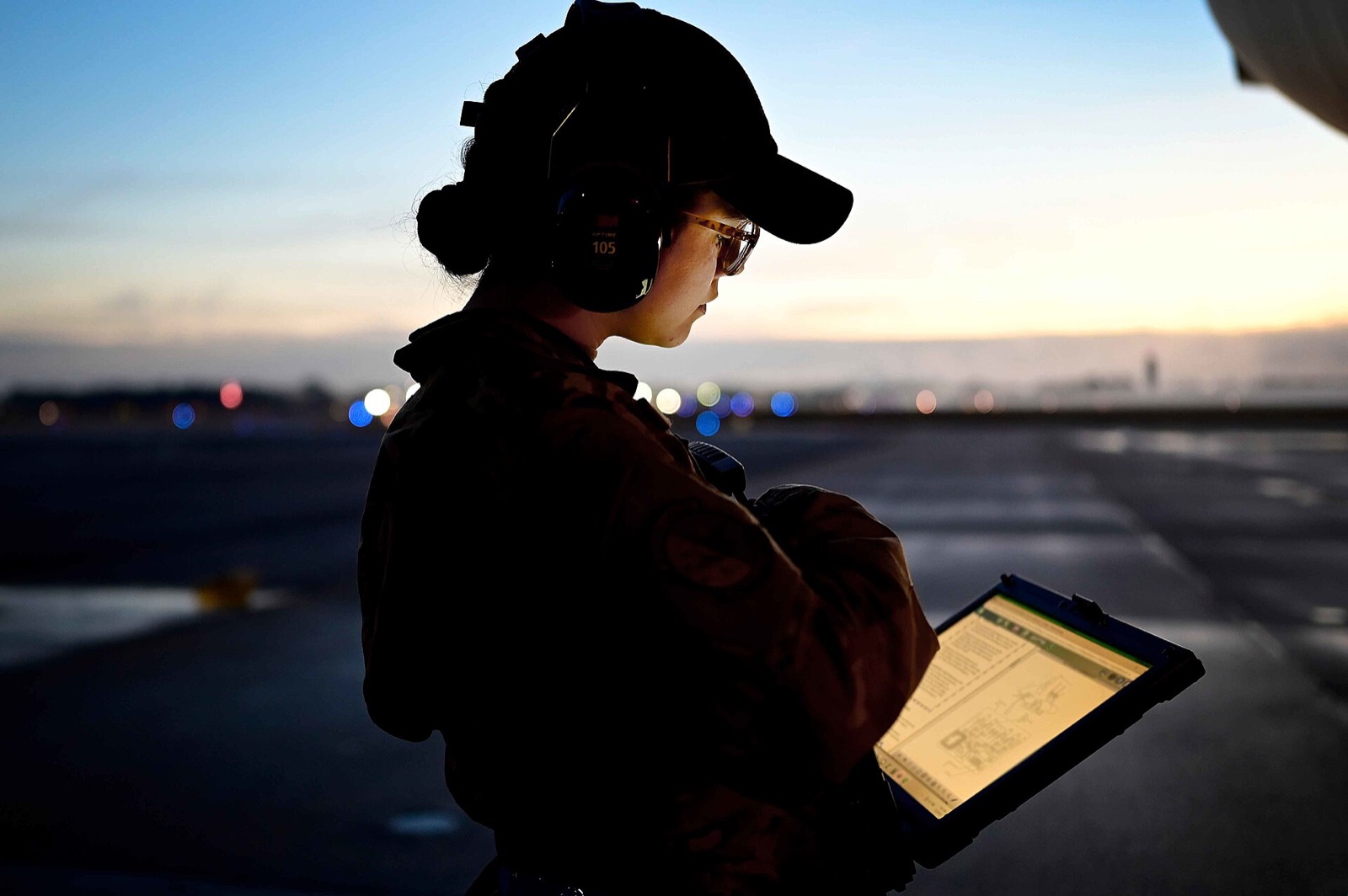 A C-17 maintainer reviews her technical order on a tablet